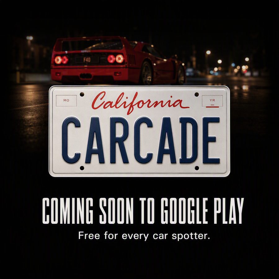 A California license plate reading CARCADE, with a red Ferrari F40 behind it at night